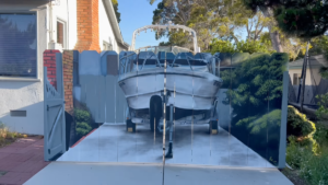 Man Forced To Hide His Boat Behind A Fence Has Super Realistic Boat Painted On The Fence